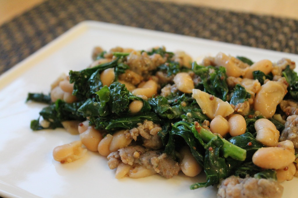 ziti pasta with sausage and kale on a plate